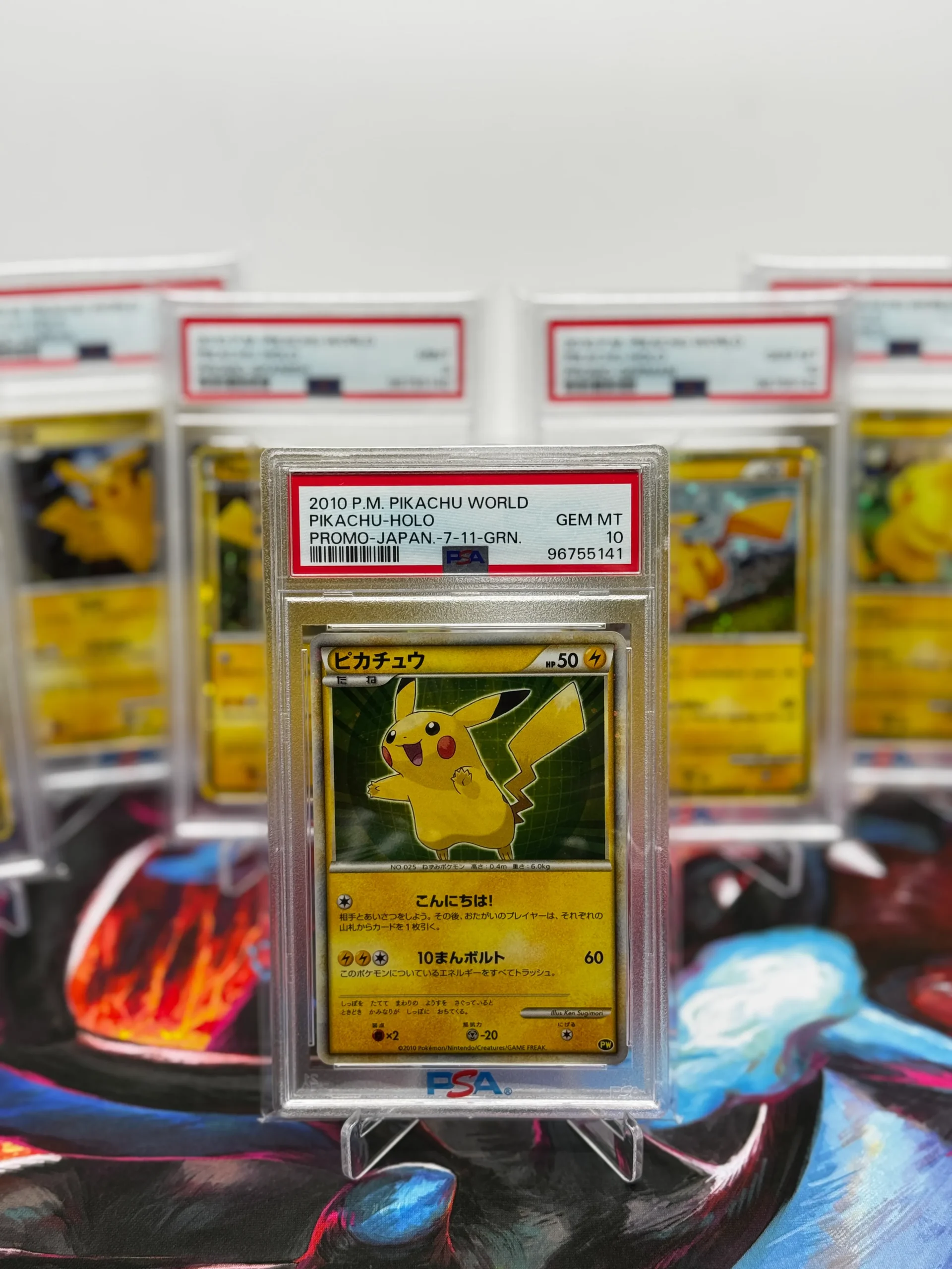 PSA 10 2010 Pikachu World Japanese promo Pokémon card displayed with other sequential PSA 10 Pikachu World cards in the background PSA 10 2010 Pikachu World Japanese promo Pokémon card displayed with other sequential PSA 10 Pikachu World cards in the background